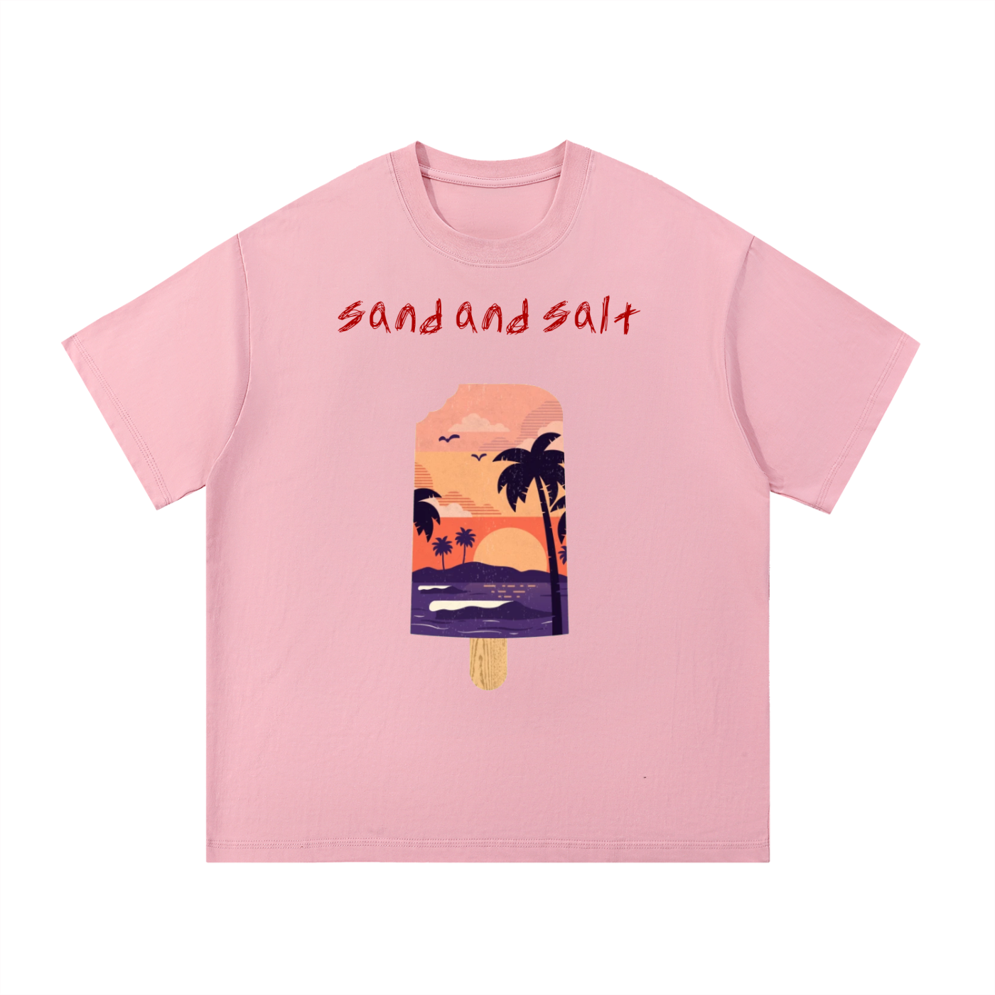 Pink t-shirt with a tropical-themed graphic and 'sand and salt' text on a white background