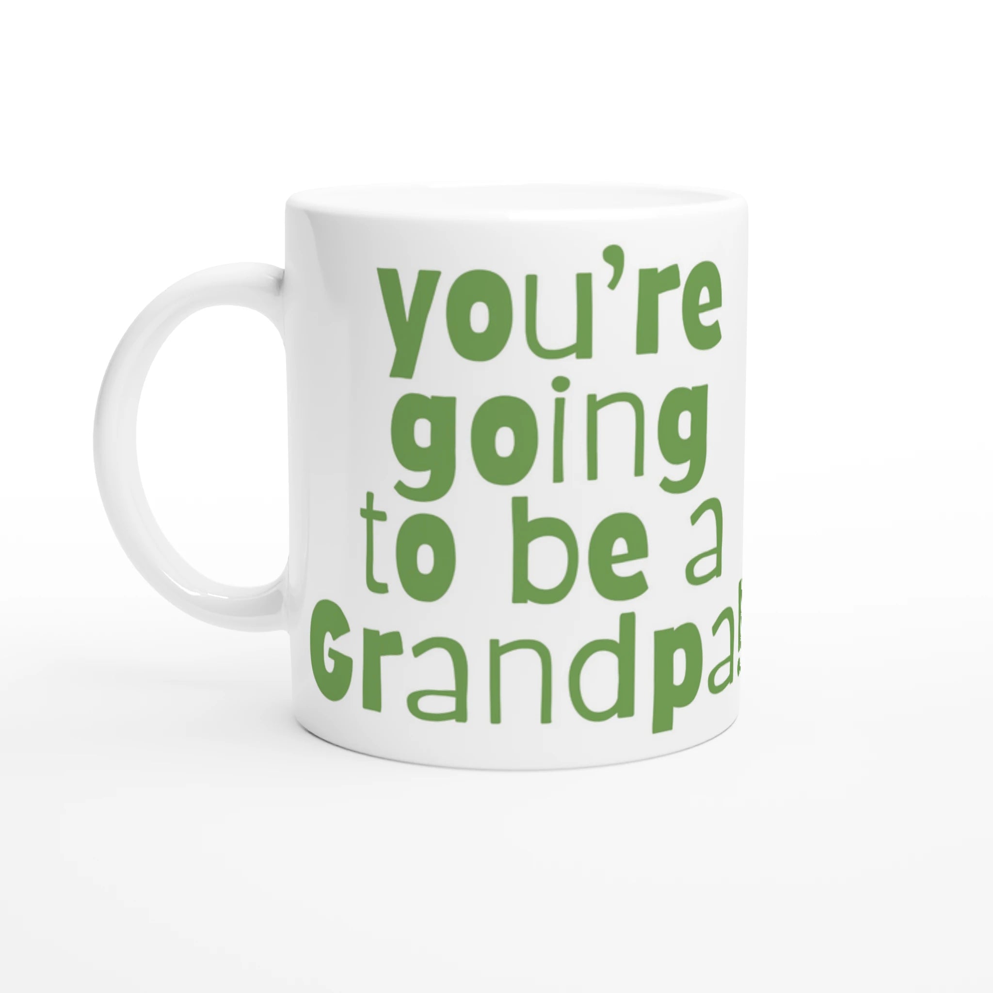 White mug with green text 'you're going to be a Grandpa' on a white background