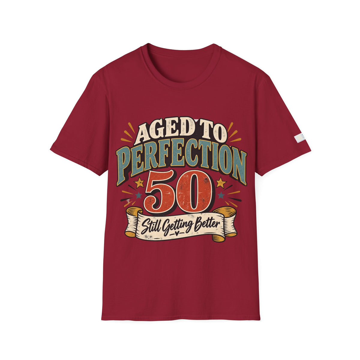 A maroon short-sleeve t-shirt with a retro-style graphic on the chest that reads 'AGED TO PERFECTION 50 Still Getting Better' in cream, green, and orange lettering, displayed on a solid white background.