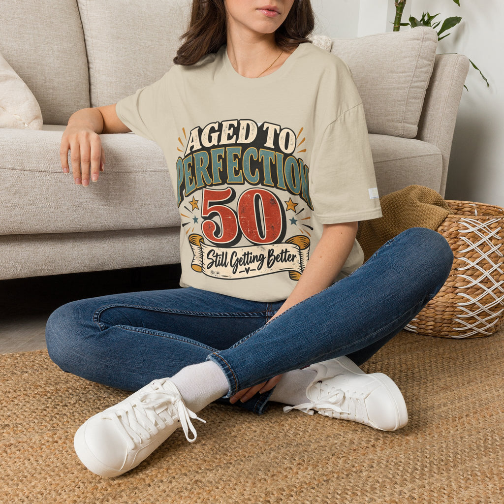 Person wearing a 'aged to 50' t-shirt sitting on the floor.
