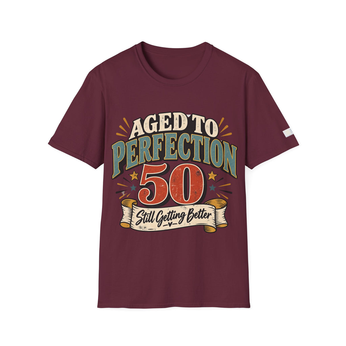 A maroon short-sleeve t-shirt with a retro-style graphic on the front that reads 'AGED TO PERFECTION 50 Still Getting Better' in cream, green, and orange lettering, displayed on a solid white background.