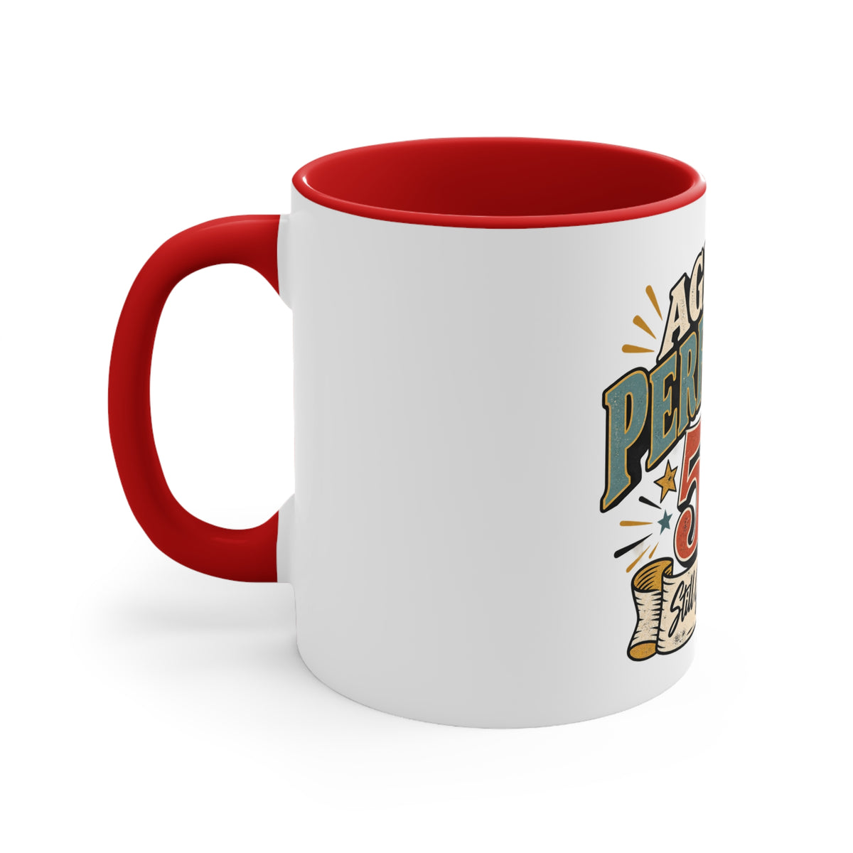 A white ceramic mug with a red handle and red interior, featuring a colorful graphic print on the side that reads 'perfection' with stars and a scroll illustration.