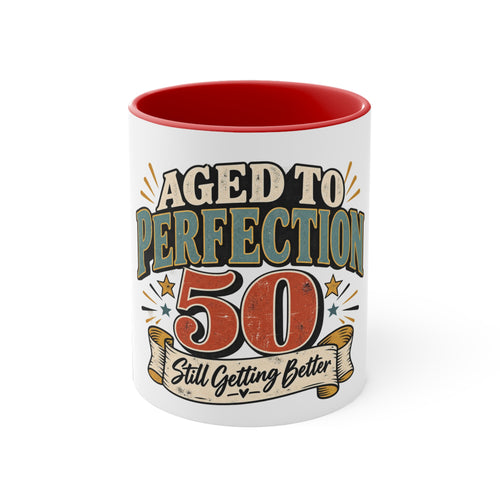 A white ceramic mug with a red interior, featuring a retro-style graphic that reads 'AGED TO PERFECTION 50 Still Getting Better' in beige, blue, and red lettering.