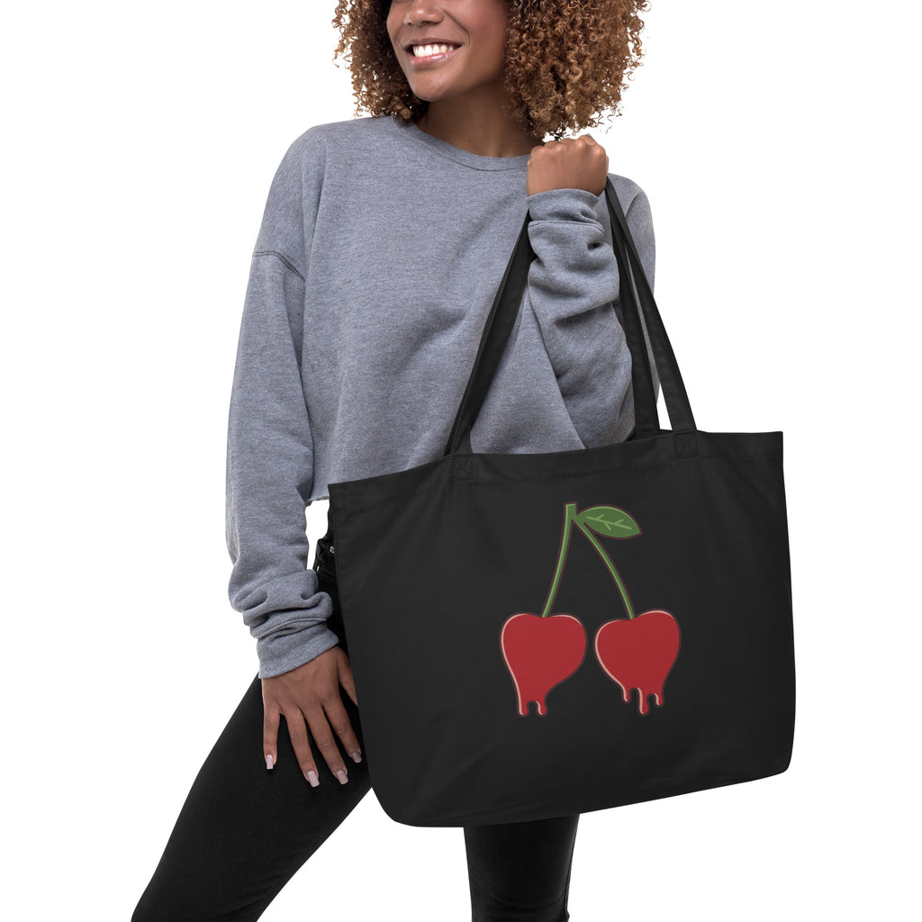 person holding black bag with red cherries