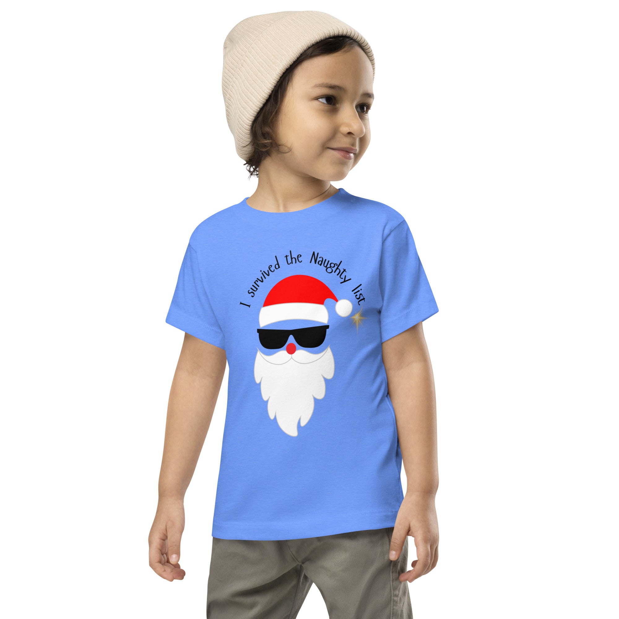 Child wearing a blue t-shirt with a Santa Claus graphic and text on a white background