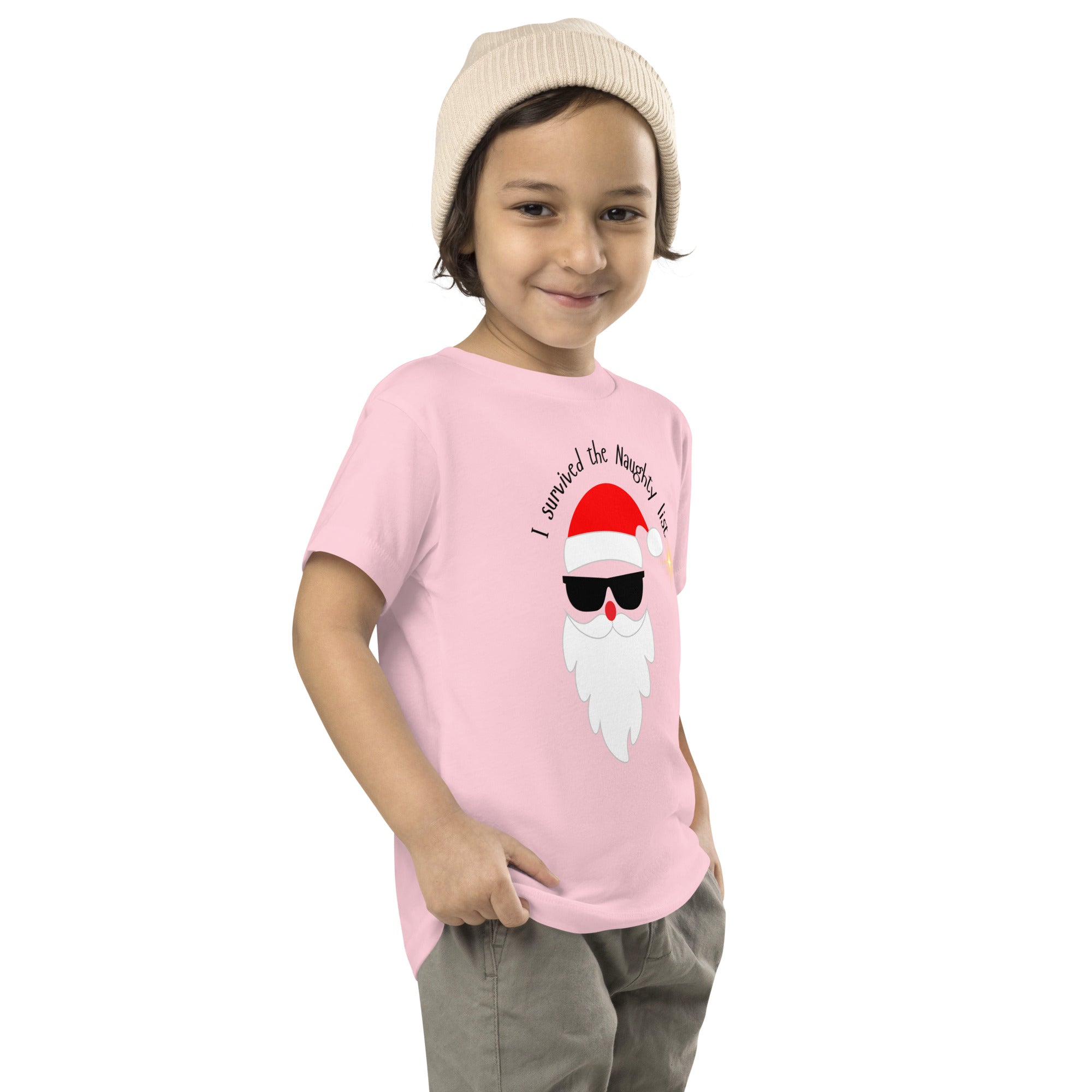 Child wearing a pink t-shirt with a graphic design on a white background