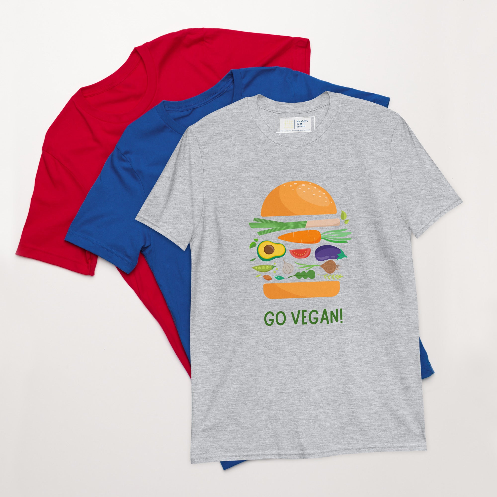 Gray t-shirt with a vegan burger graphic and 'GO VEGAN!' text, surrounded by red and blue shirts on a white background.