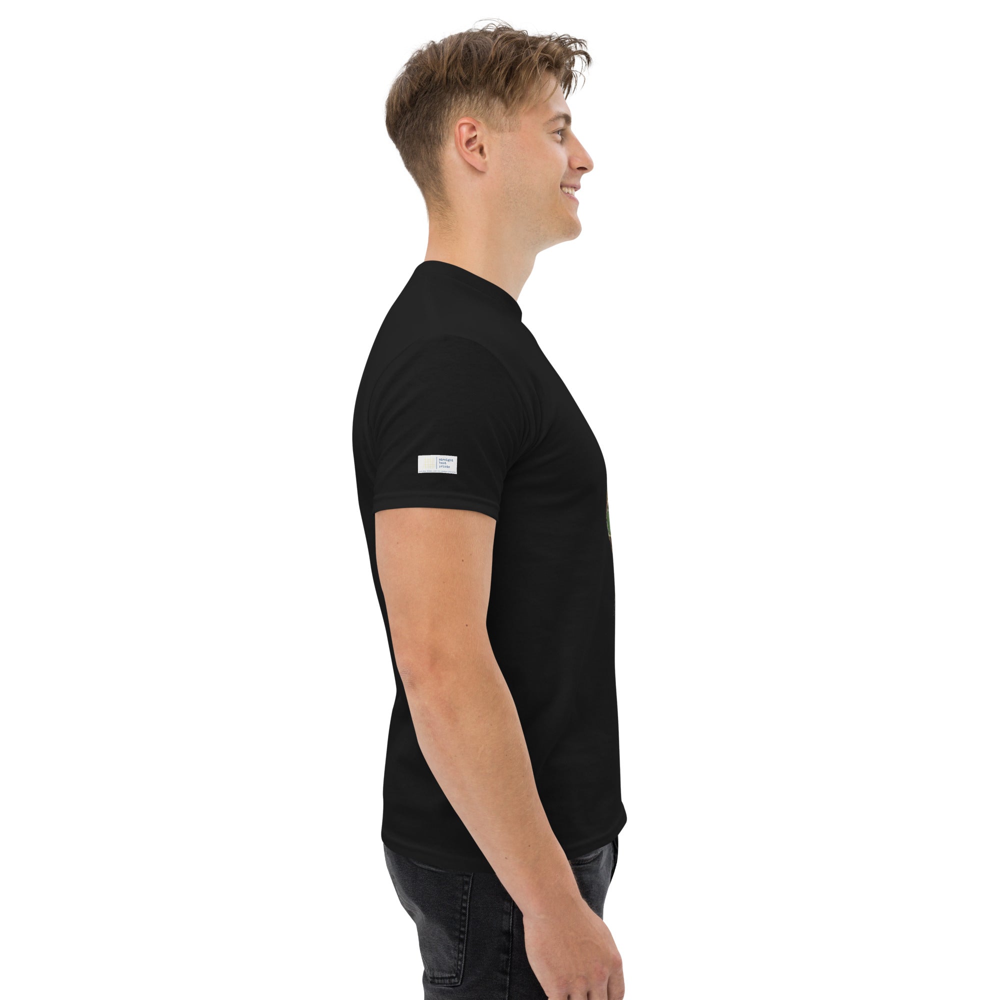 Man wearing a black t-shirt with a small white logo on a white background
