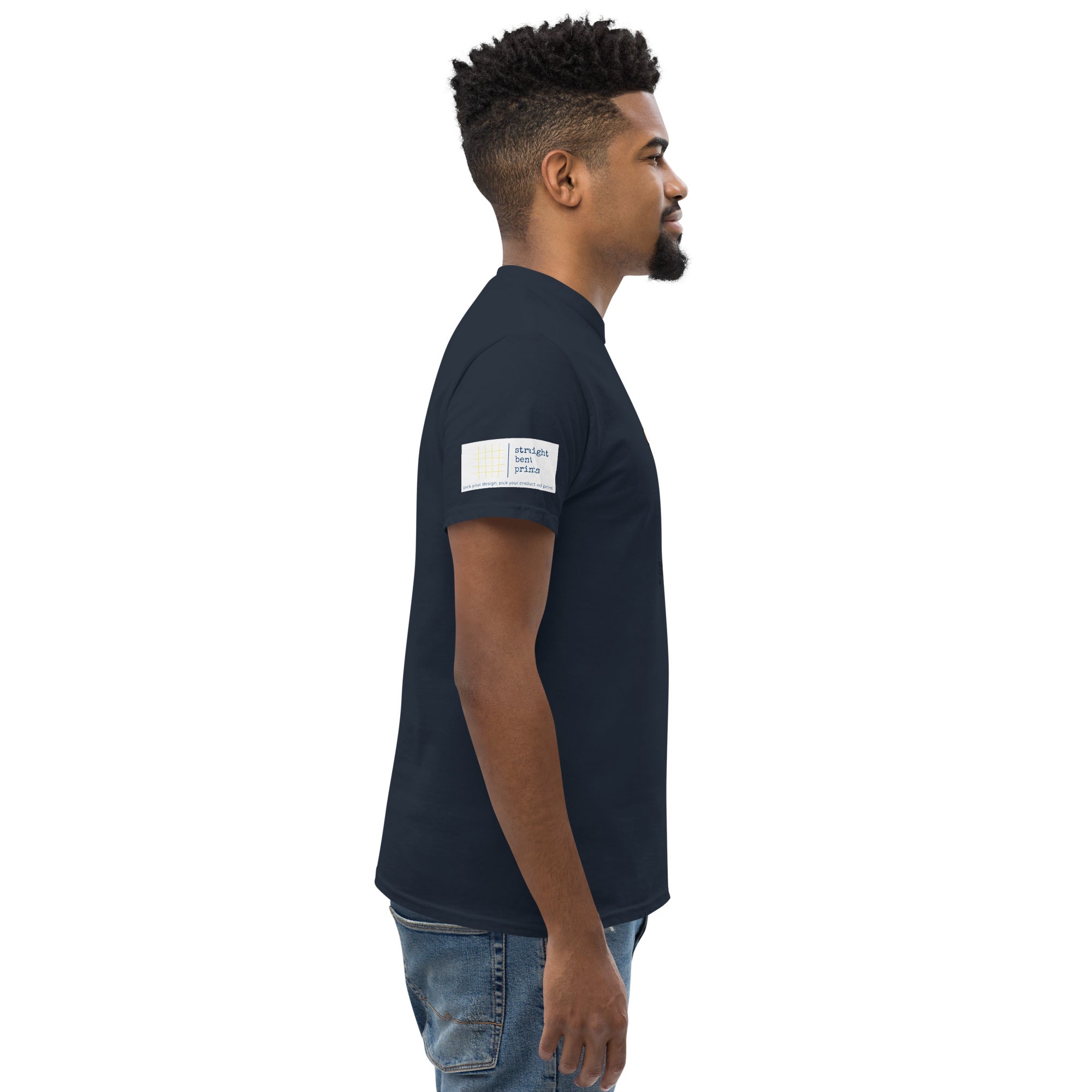 Man wearing a navy blue t-shirt with a white logo on a white background