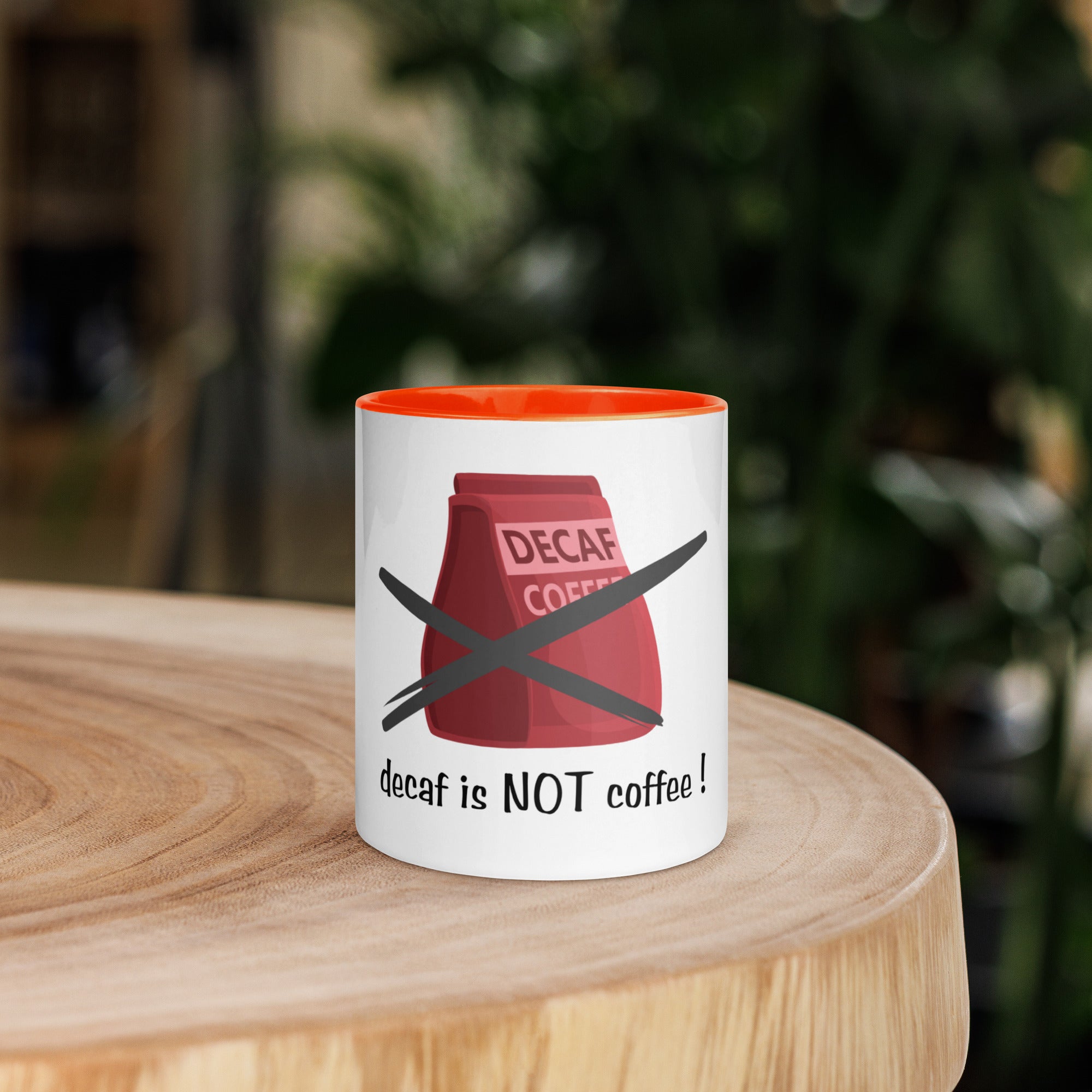 Mug with 'decaf is NOT coffee!' design on a wooden surface
