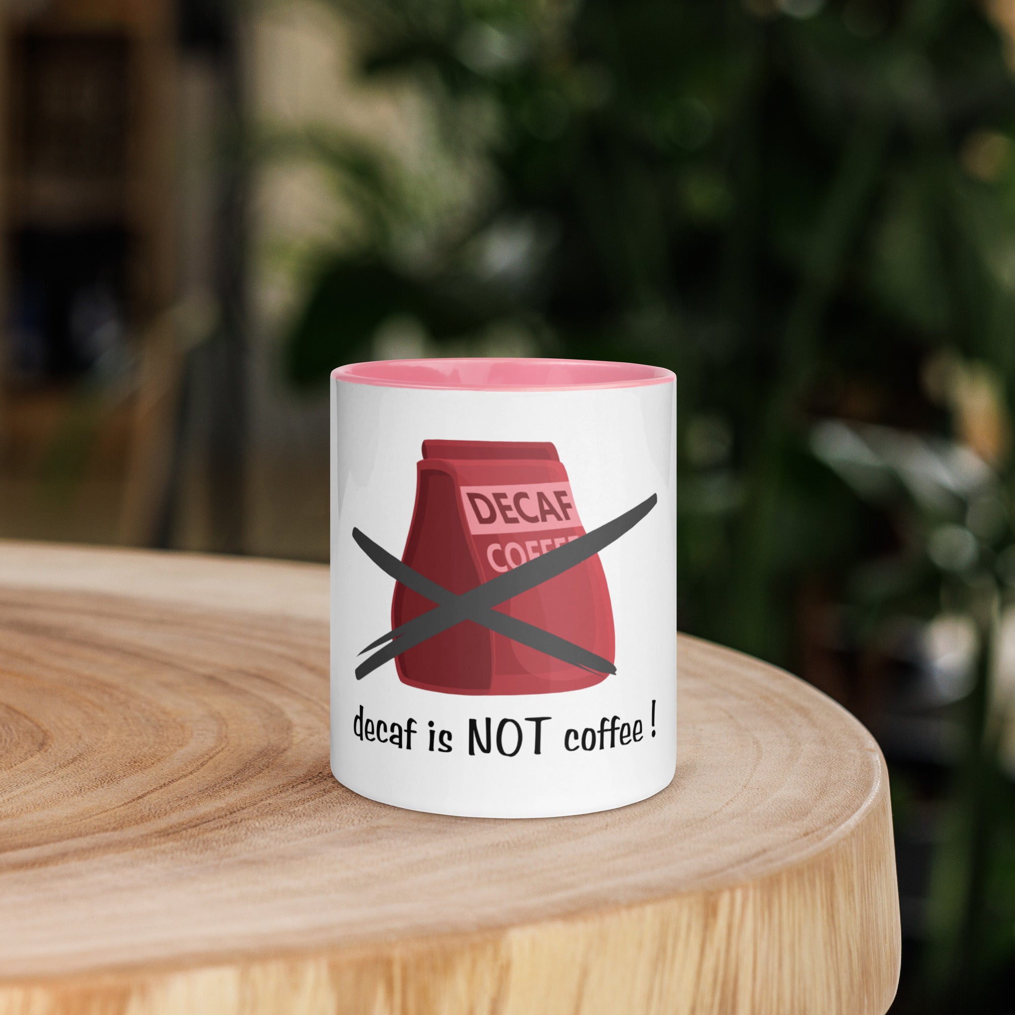 Mug with a red coffee bag graphic and text on a wooden surface