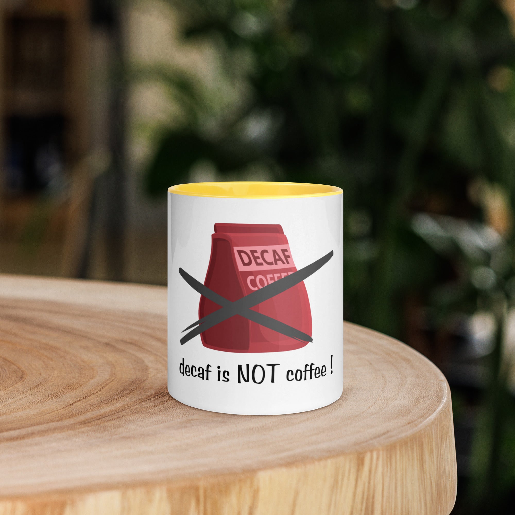 Mug with 'decaf is NOT coffee!' design on a wooden surface