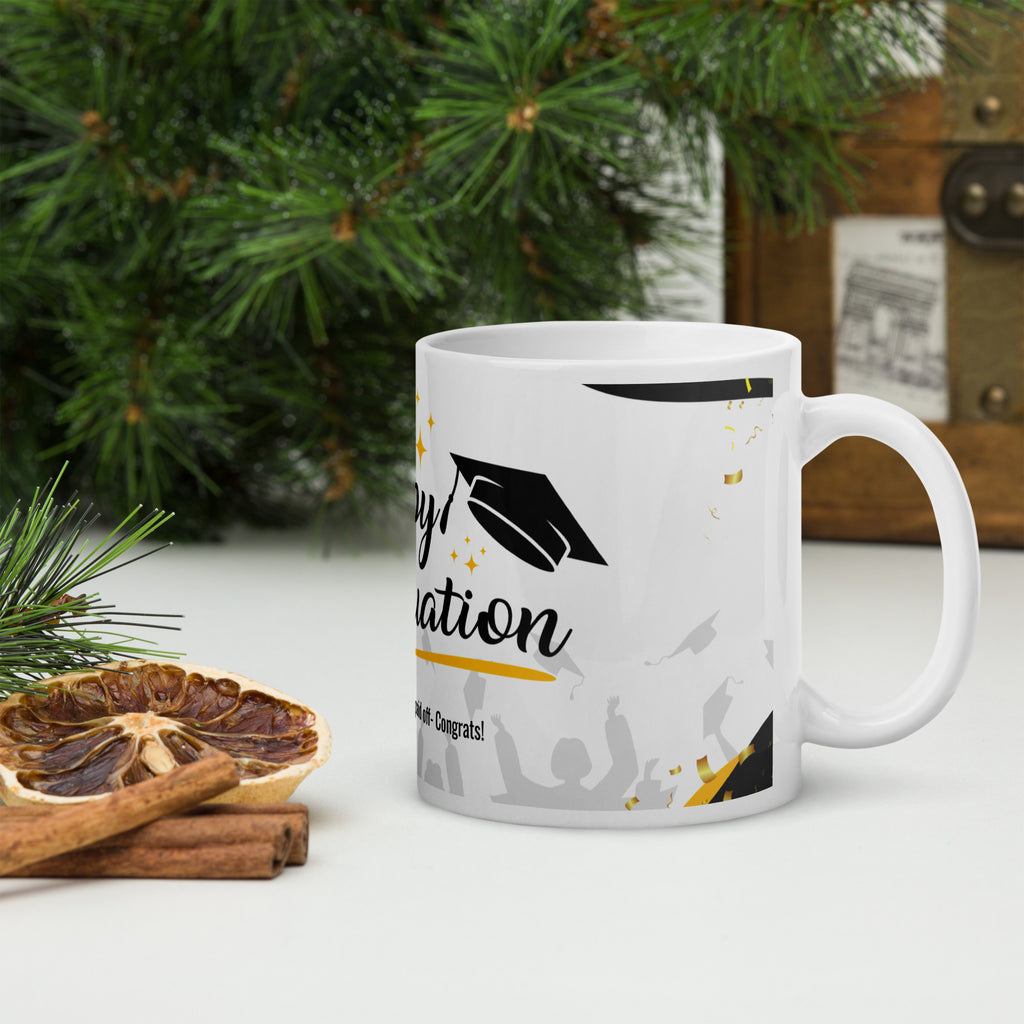 Graduation-themed mug on a table with decorative elements
