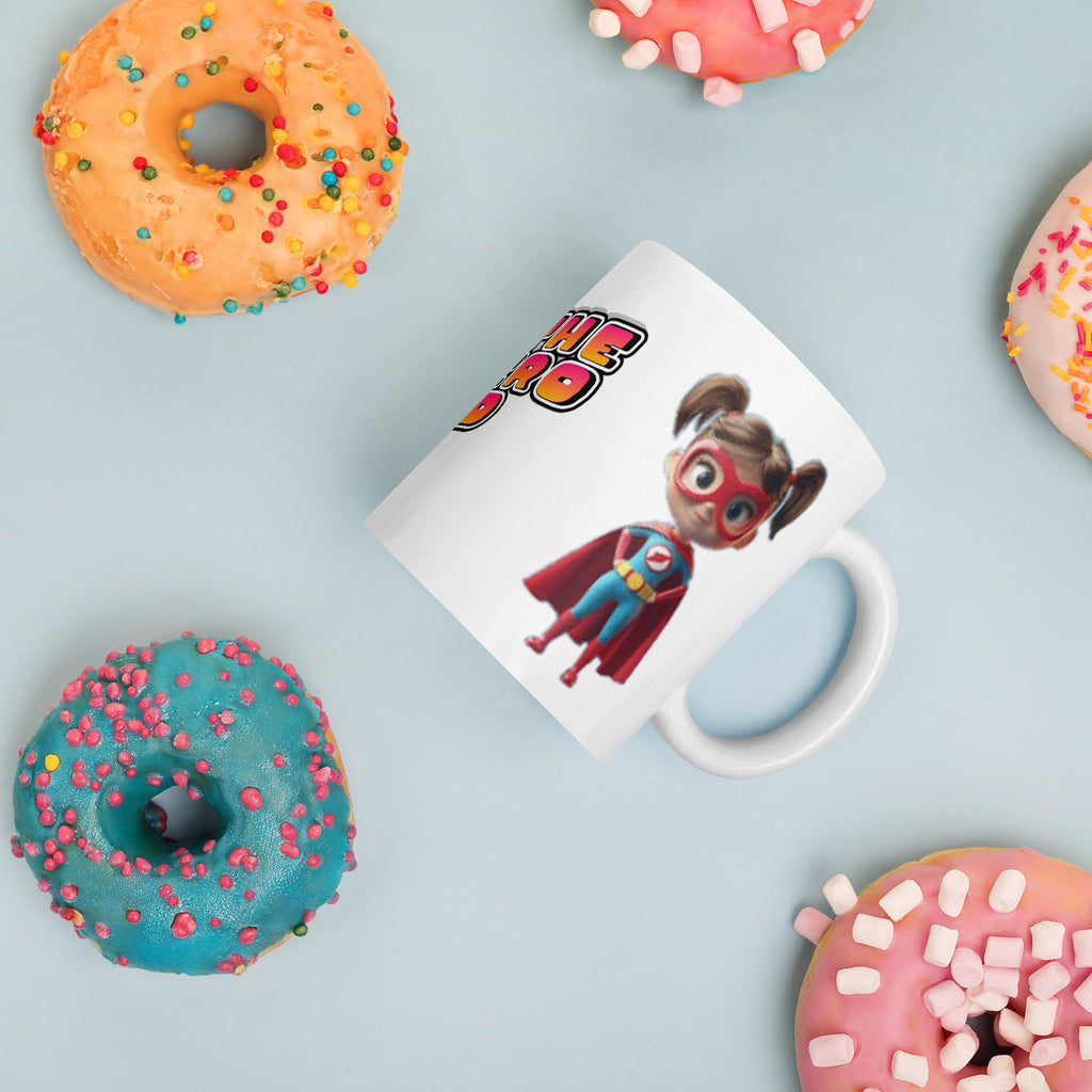 Mug with superhero design surrounded by colorful donuts on a light blue background