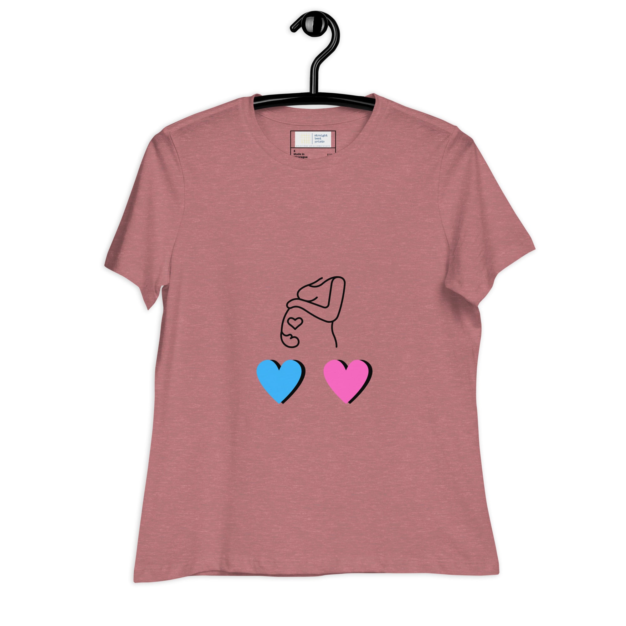 Pink t-shirt with a design of a hand holding two hearts, one blue and one pink, on a white background.