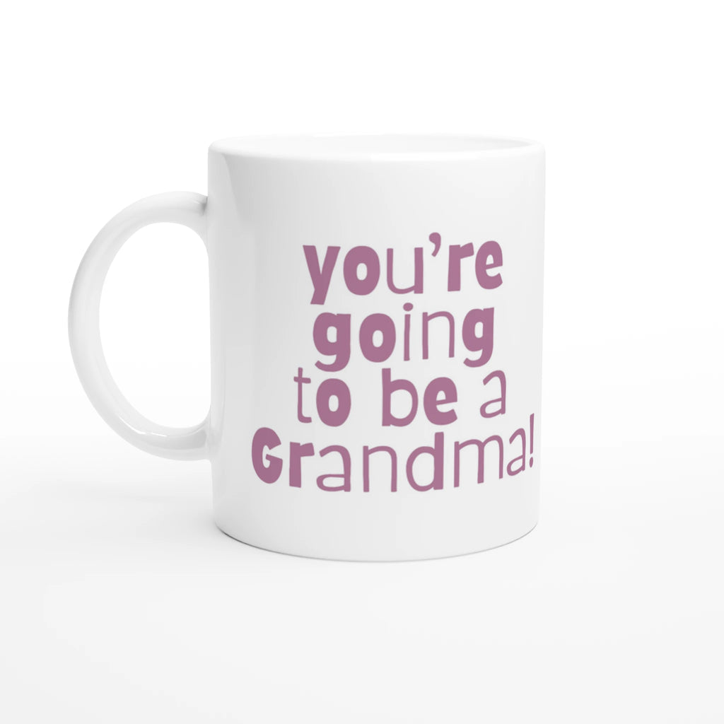 White mug with pink text 'you're going to be a Grandma!' on a white background