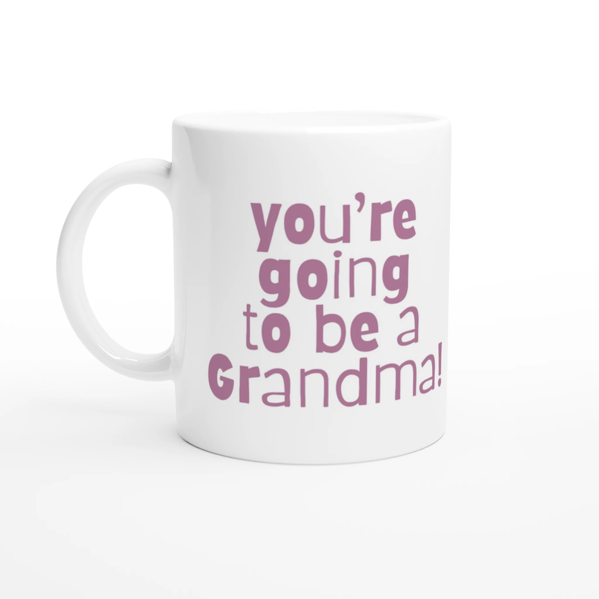 White mug with pink text 'you're going to be a Grandma!' on a white background